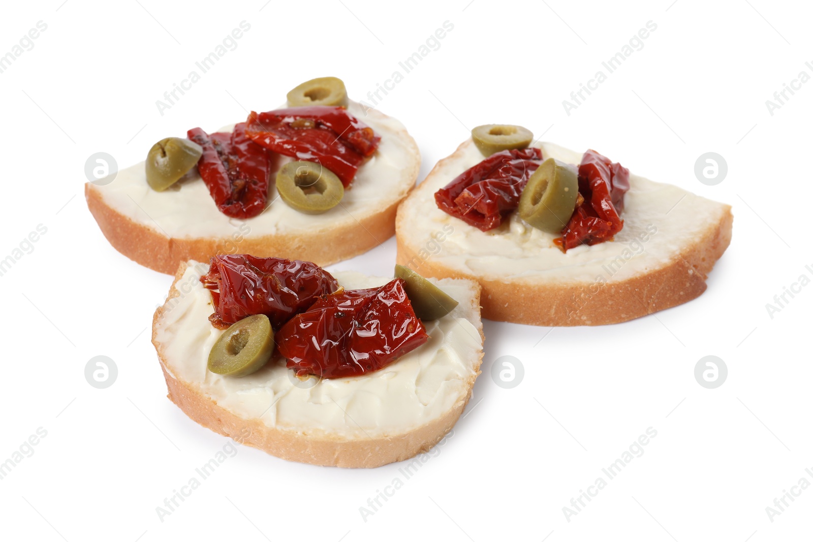 Photo of Delicious bruschettas with ricotta cheese, sun dried tomatoes and olives isolated on white