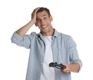 Surprised man playing video games with controller on white background
