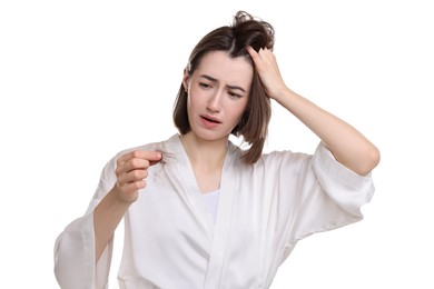 Photo of Stressed woman holding clump of lost hair on white background. Alopecia problem