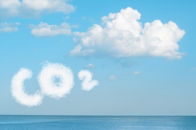 Image of Blue sky with CO2 chemical formula and clouds over sea. Carbon dioxide emissions