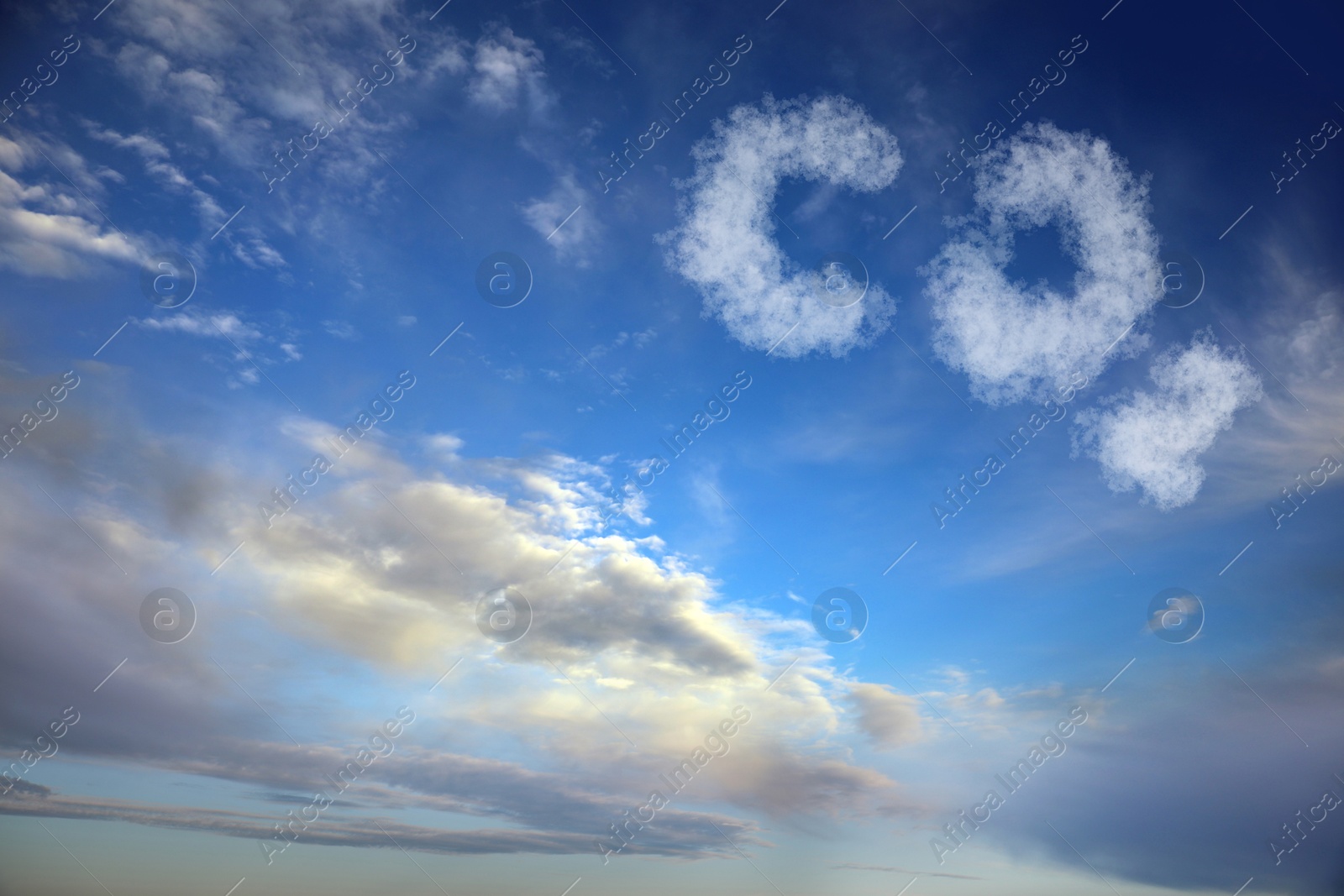 Image of Blue sky with CO2 chemical formula and clouds. Carbon dioxide emissions