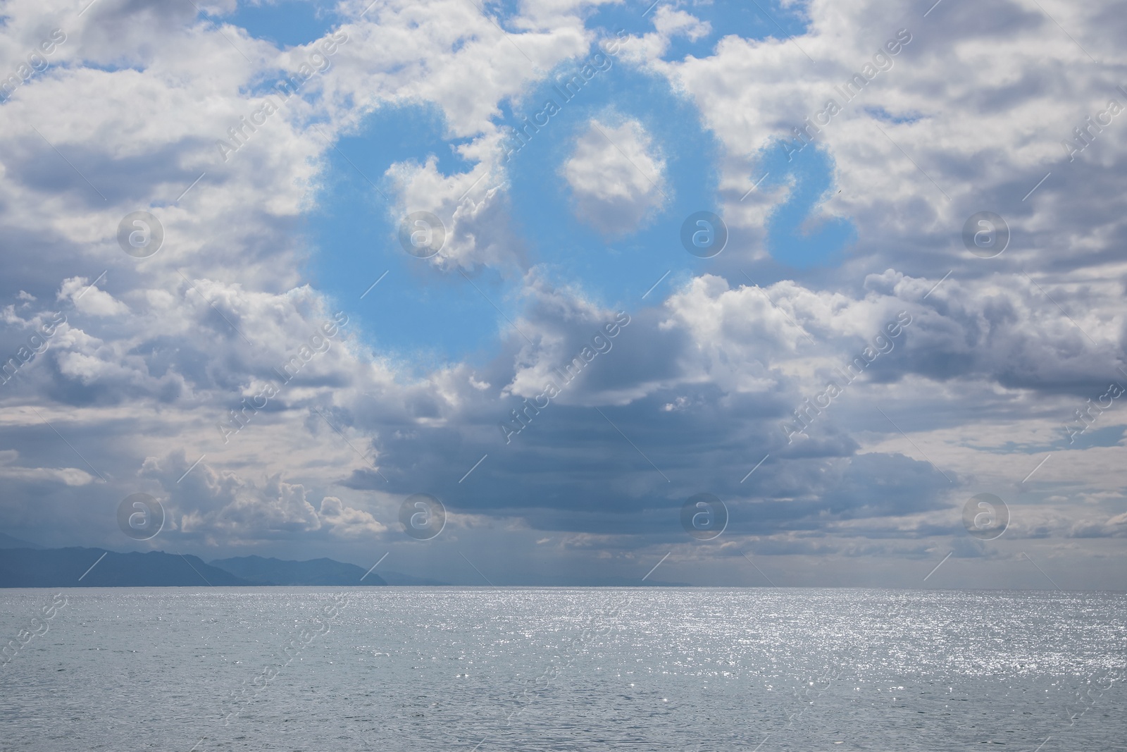 Image of Blue sky with CO2 chemical formula and clouds over sea. Carbon dioxide emissions