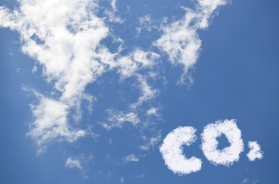 Image of Blue sky with CO2 chemical formula and clouds. Carbon dioxide emissions