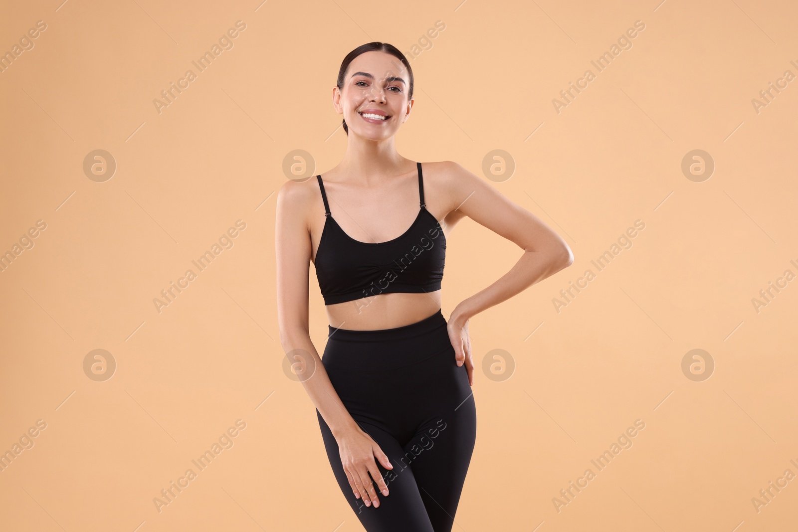 Photo of Diet and weight loss concept. Beautiful young woman with slim body against beige background