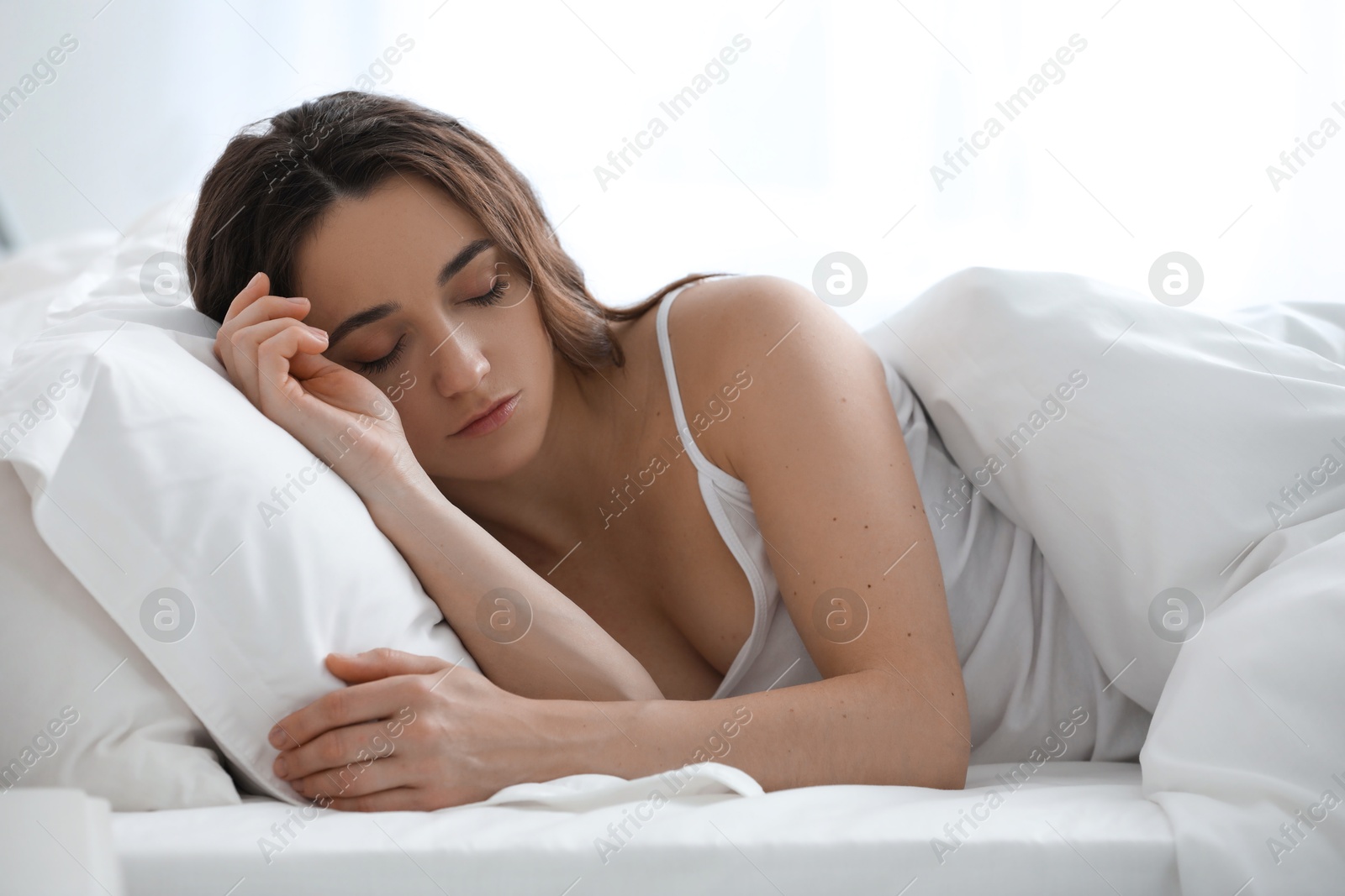 Photo of Bedtime. Beautiful woman sleeping in bed at home