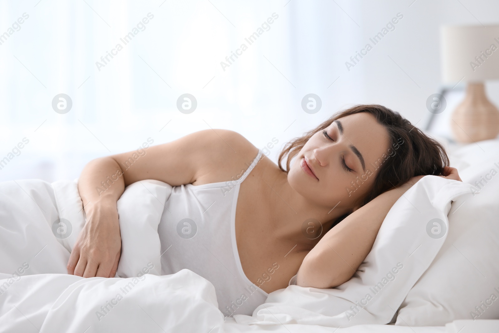 Photo of Bedtime. Beautiful woman sleeping in bed at home