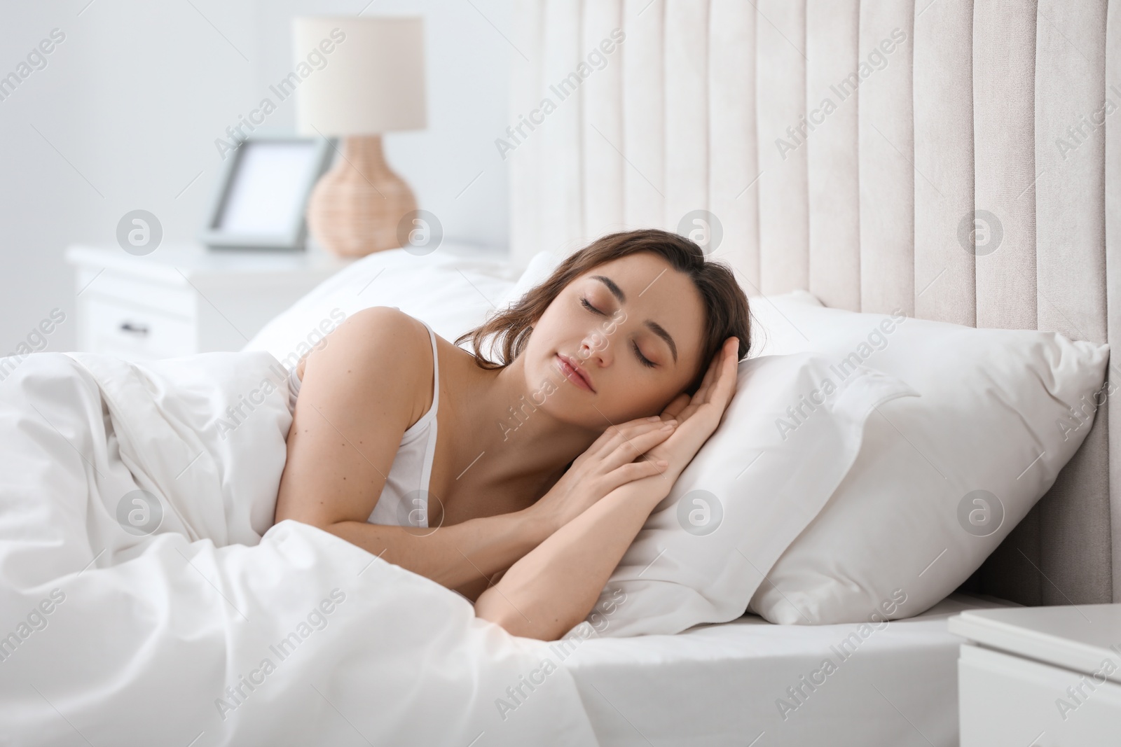 Photo of Bedtime. Beautiful woman sleeping in bed at home