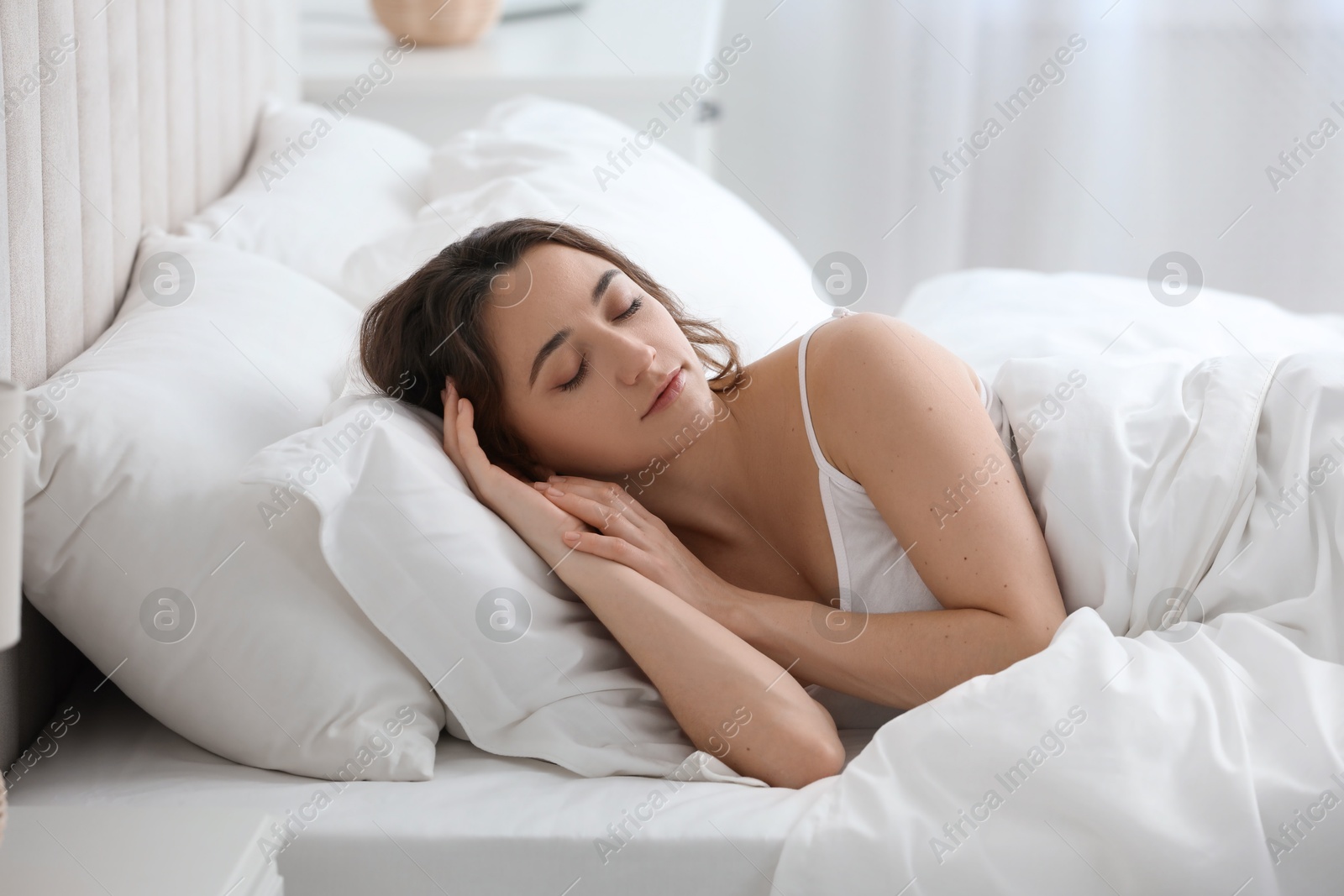 Photo of Bedtime. Beautiful woman sleeping in bed at home