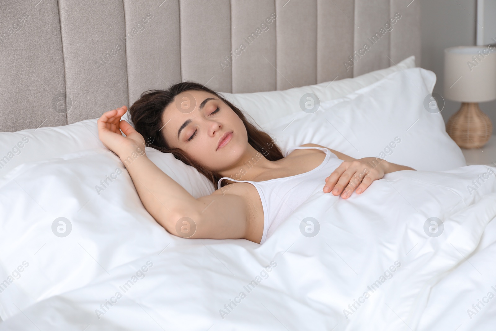 Photo of Bedtime. Beautiful woman sleeping in bed at home