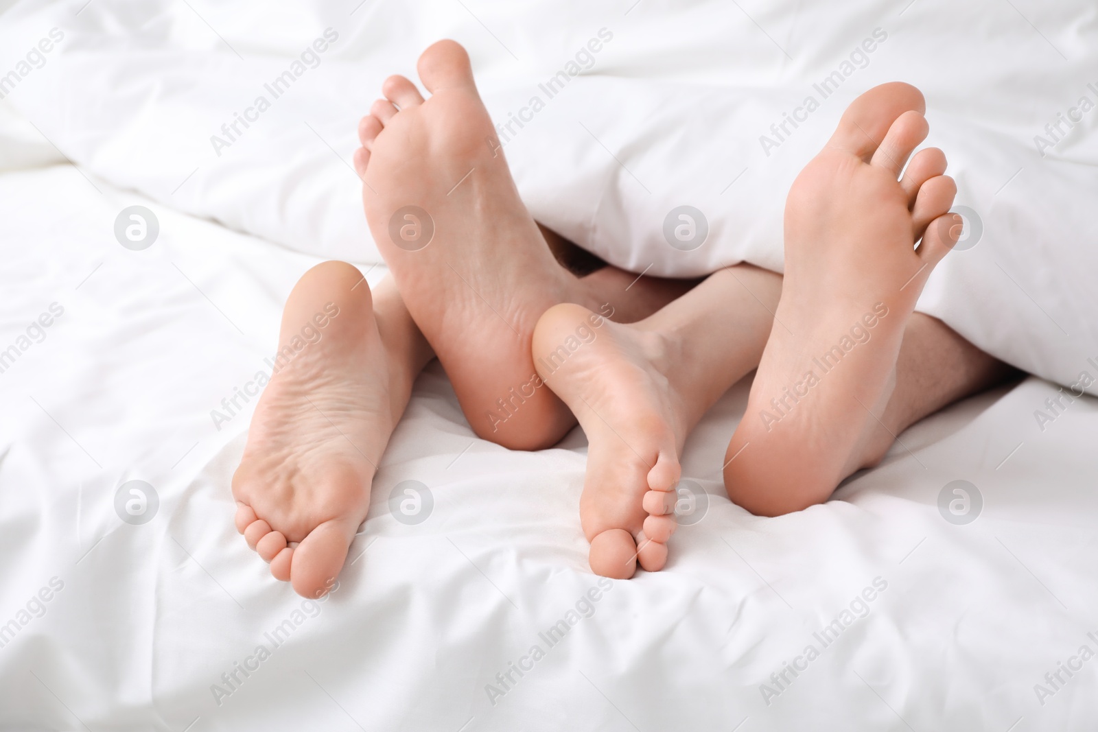 Photo of Lovely couple lying in bed, closeup view