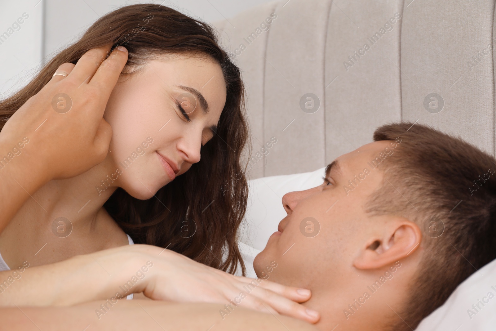 Photo of Lovely couple spending time together in bed