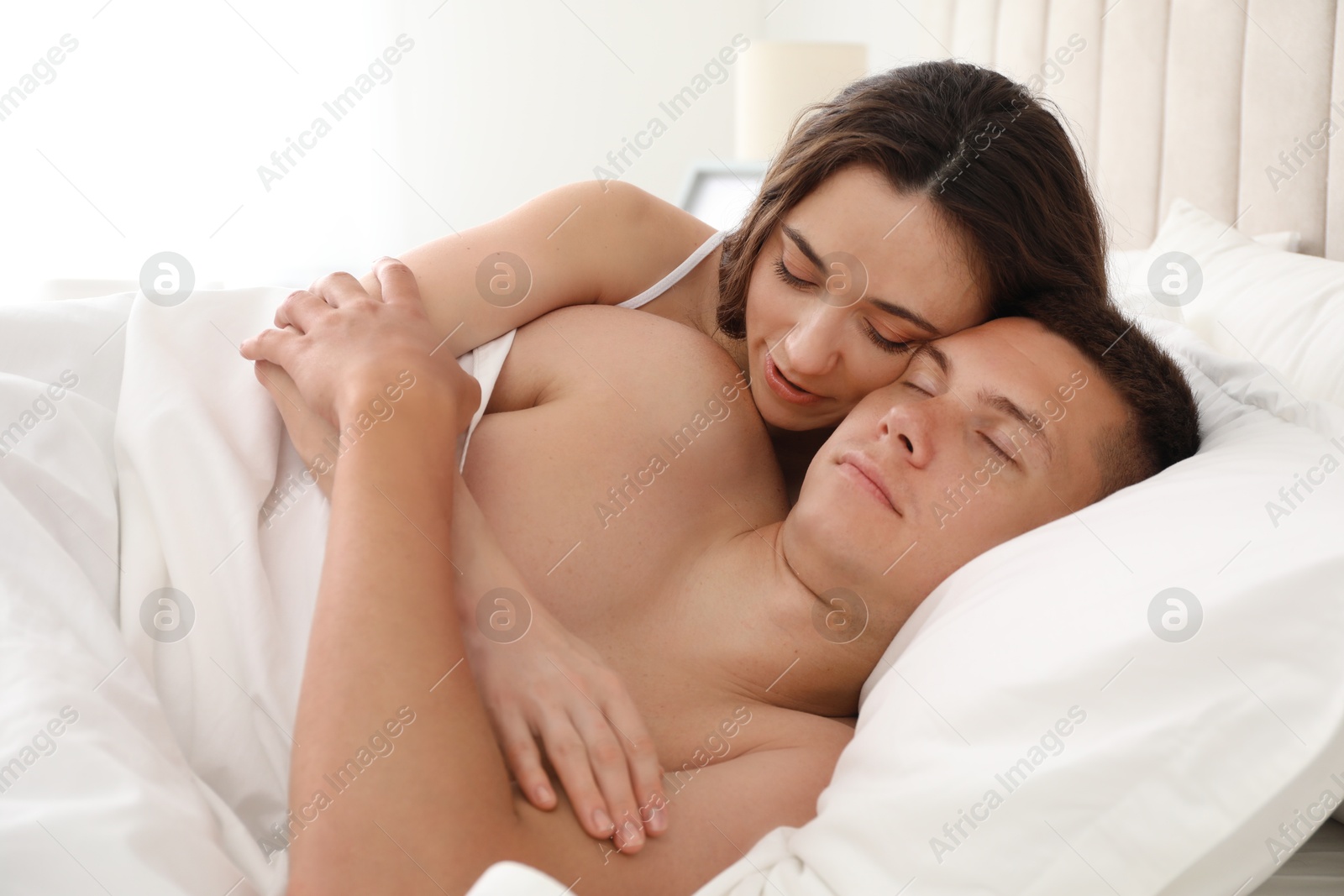 Photo of Lovely couple lying in bed at home