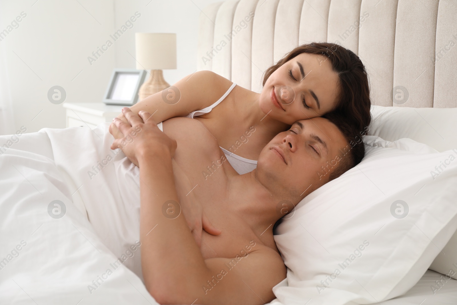Photo of Lovely couple lying in bed at home