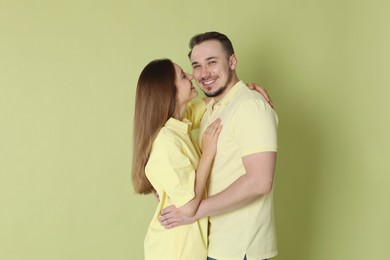 Photo of Cute couple hugging on green background. Strong relationship