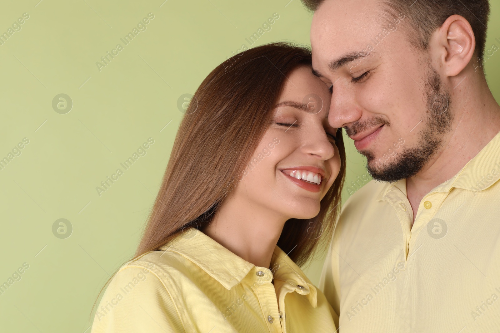 Photo of Happy couple on green background. Strong relationship