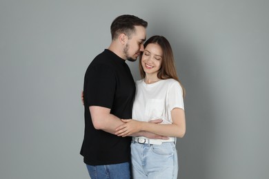 Photo of Happy couple hugging on grey background. Strong relationship