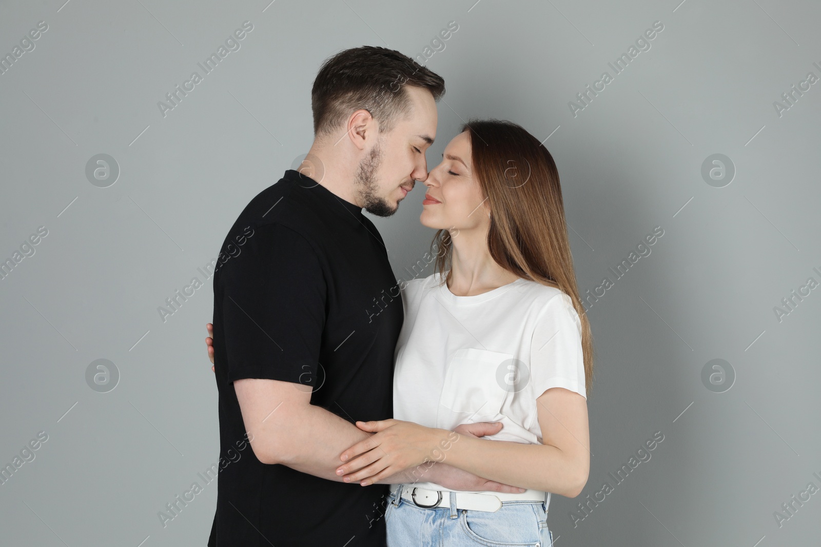 Photo of Happy couple hugging on grey background. Strong relationship