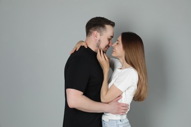 Photo of Happy couple hugging on grey background. Strong relationship