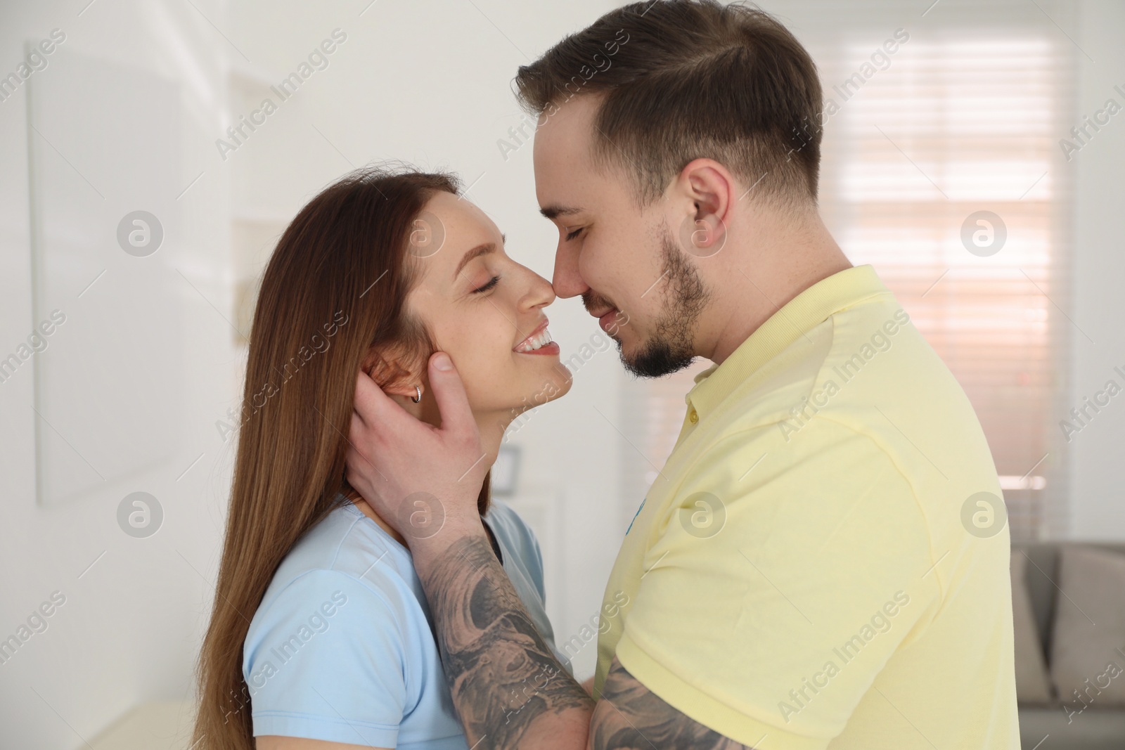 Photo of Happy couple kissing at home. Strong relationship