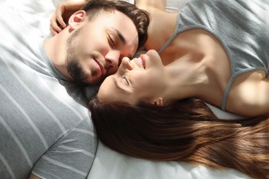 Family portrait of lovely couple on bed at home