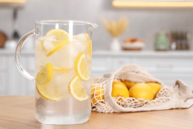 Freshly made lemonade in jug on wooden table indoors