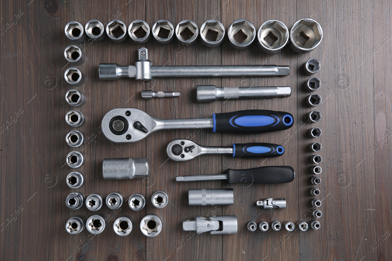 Photo of Different auto mechanic's tools on wooden table, flat lay