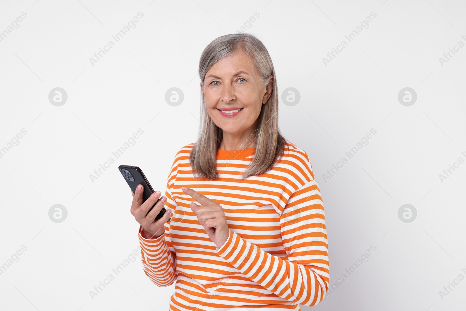 Photo of Senior woman with phone on light grey background