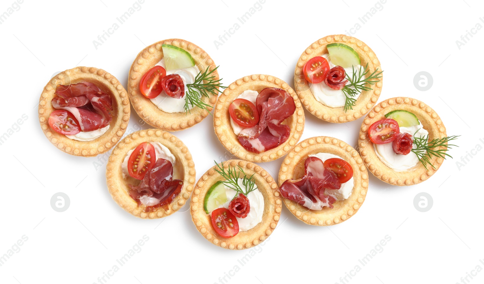 Photo of Delicious canapes with jamon, dry smoked sausages and vegetables isolated on white, top view