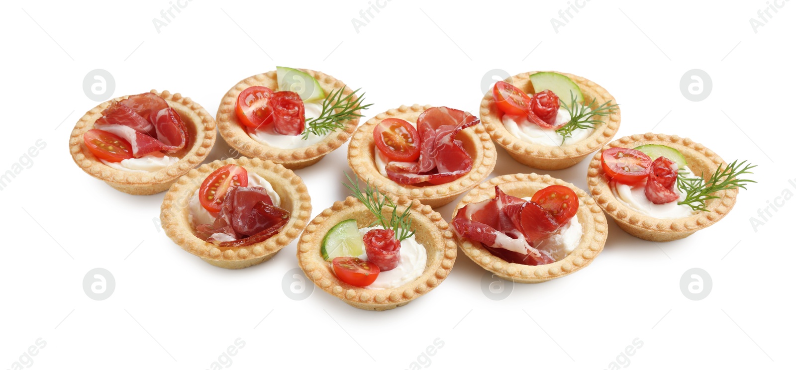 Photo of Delicious canapes with jamon, dry smoked sausages and vegetables isolated on white