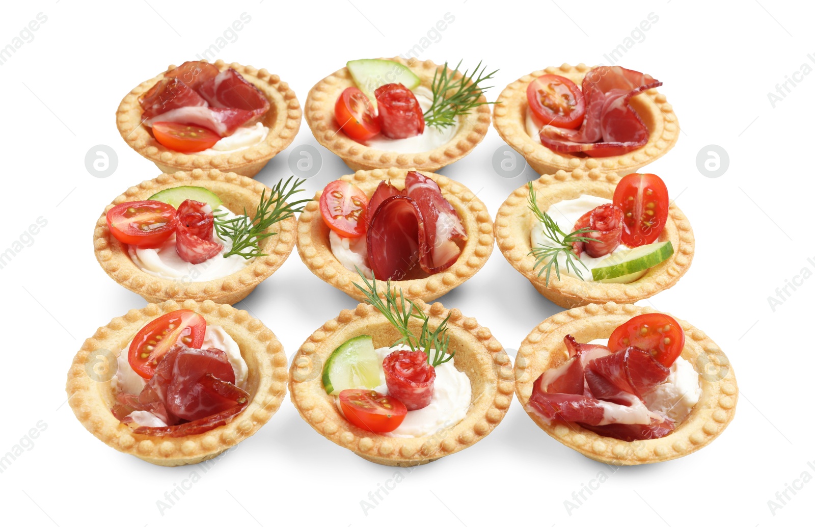 Photo of Delicious canapes with jamon, dry smoked sausages and vegetables isolated on white