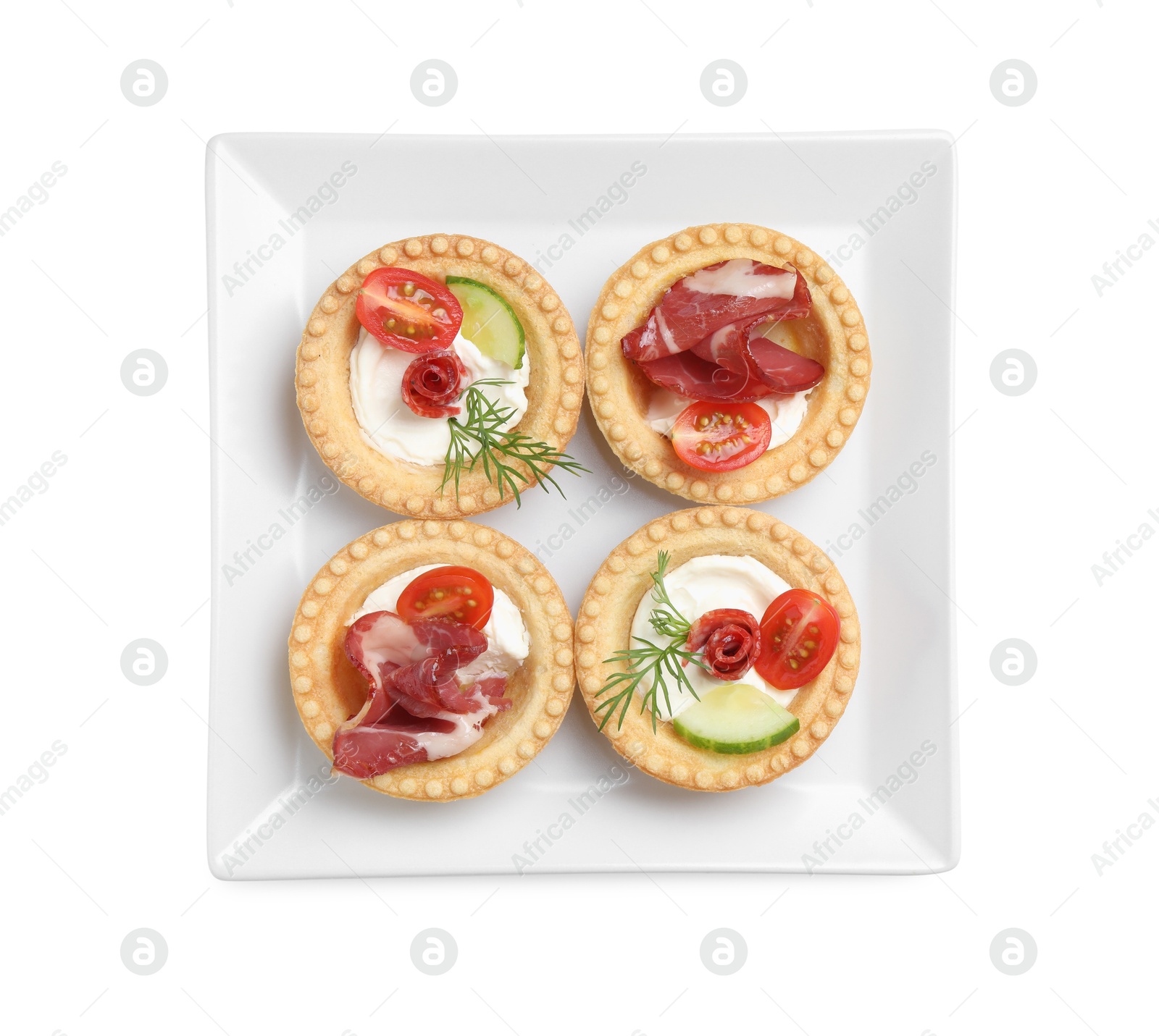 Photo of Delicious canapes with jamon, dry smoked sausages and vegetables isolated on white, top view