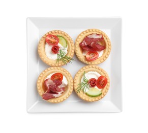 Delicious canapes with jamon, dry smoked sausages and vegetables isolated on white, top view