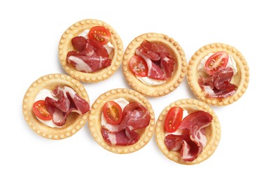 Photo of Delicious canapes with jamon, cream cheese and cherry tomatoes isolated on white, top view