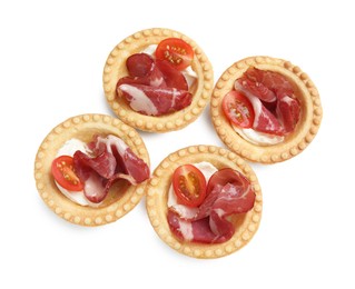 Photo of Delicious canapes with jamon, cream cheese and cherry tomatoes isolated on white, top view