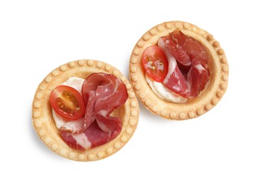 Photo of Delicious canapes with jamon, cream cheese and cherry tomatoes isolated on white, top view