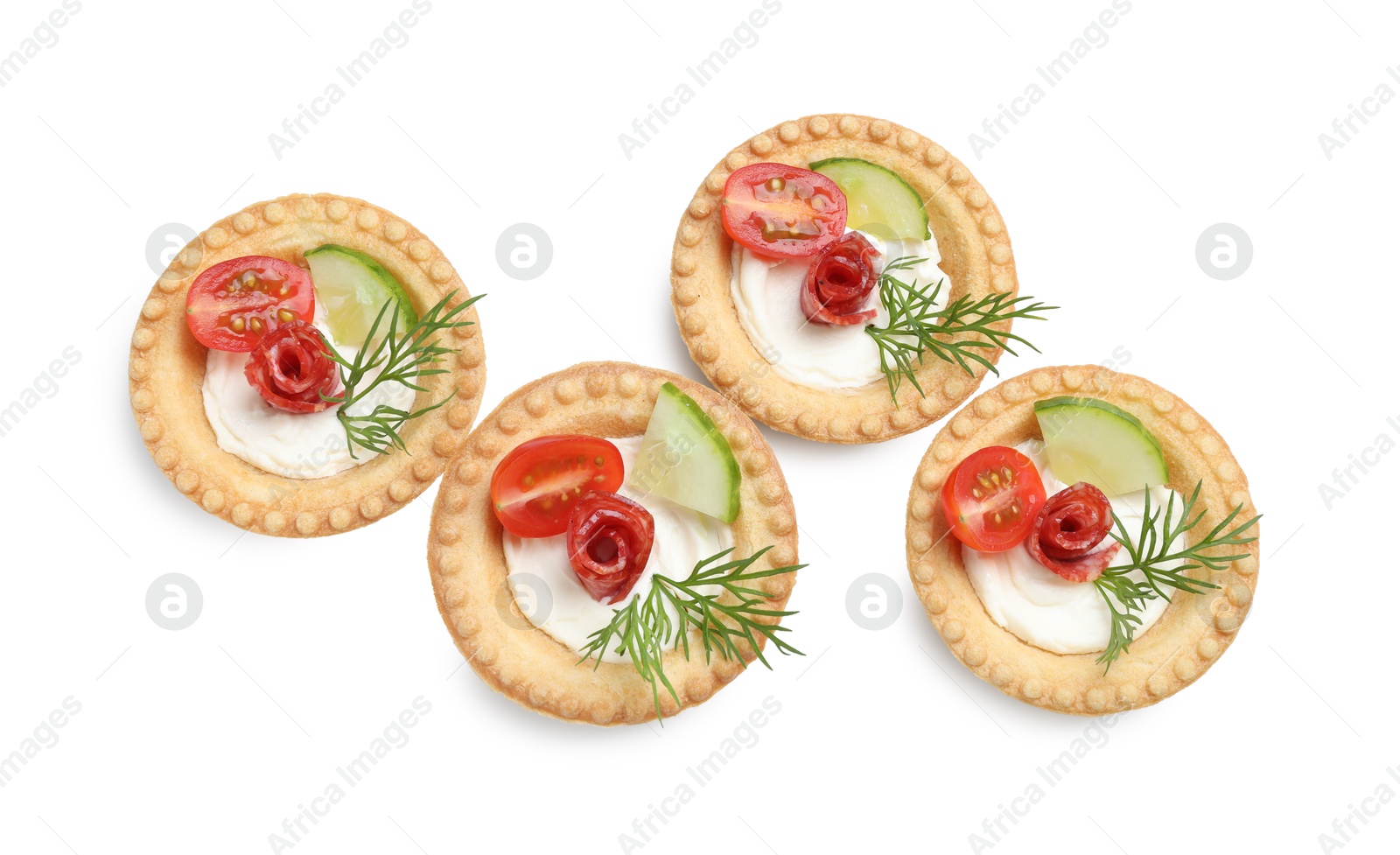 Photo of Delicious canapes with dry smoked sausages, cream cheese and vegetables isolated on white, top view