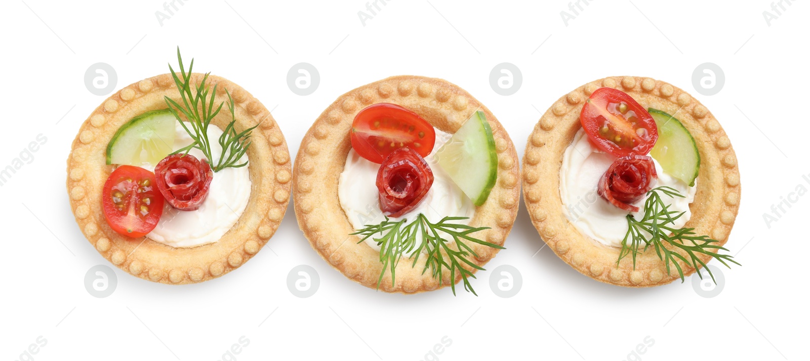 Photo of Delicious canapes with dry smoked sausages, cream cheese and vegetables isolated on white, top view