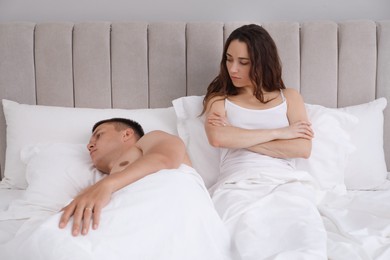 Offended couple after quarrel in bed. Relationship problem