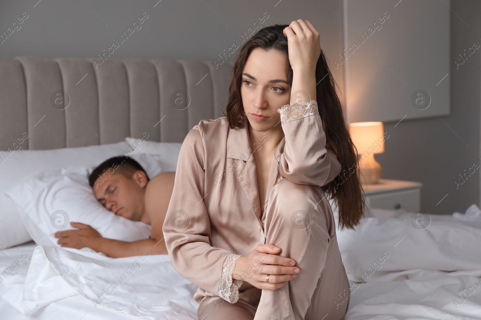 Photo of Offended couple after quarrel in bedroom. Relationship problem