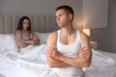 Photo of Offended couple after quarrel in bedroom. Relationship problem