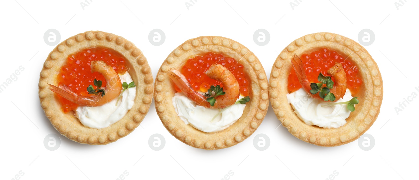 Photo of Delicious canapes with shrimps, red caviar and cream cheese isolated on white, top view