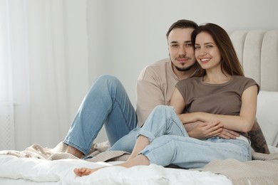 Photo of Family portrait of lovely couple on bed at home