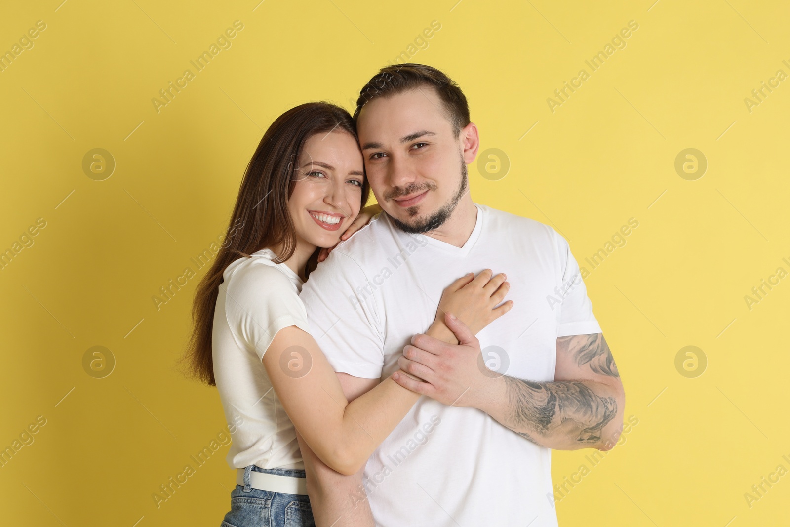 Photo of Portrait of cute couple on yellow background