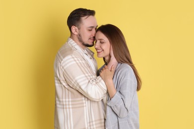 Photo of Happy couple on yellow background. Strong relationship