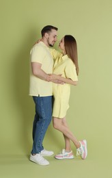 Photo of Happy couple hugging on green background. Strong relationship
