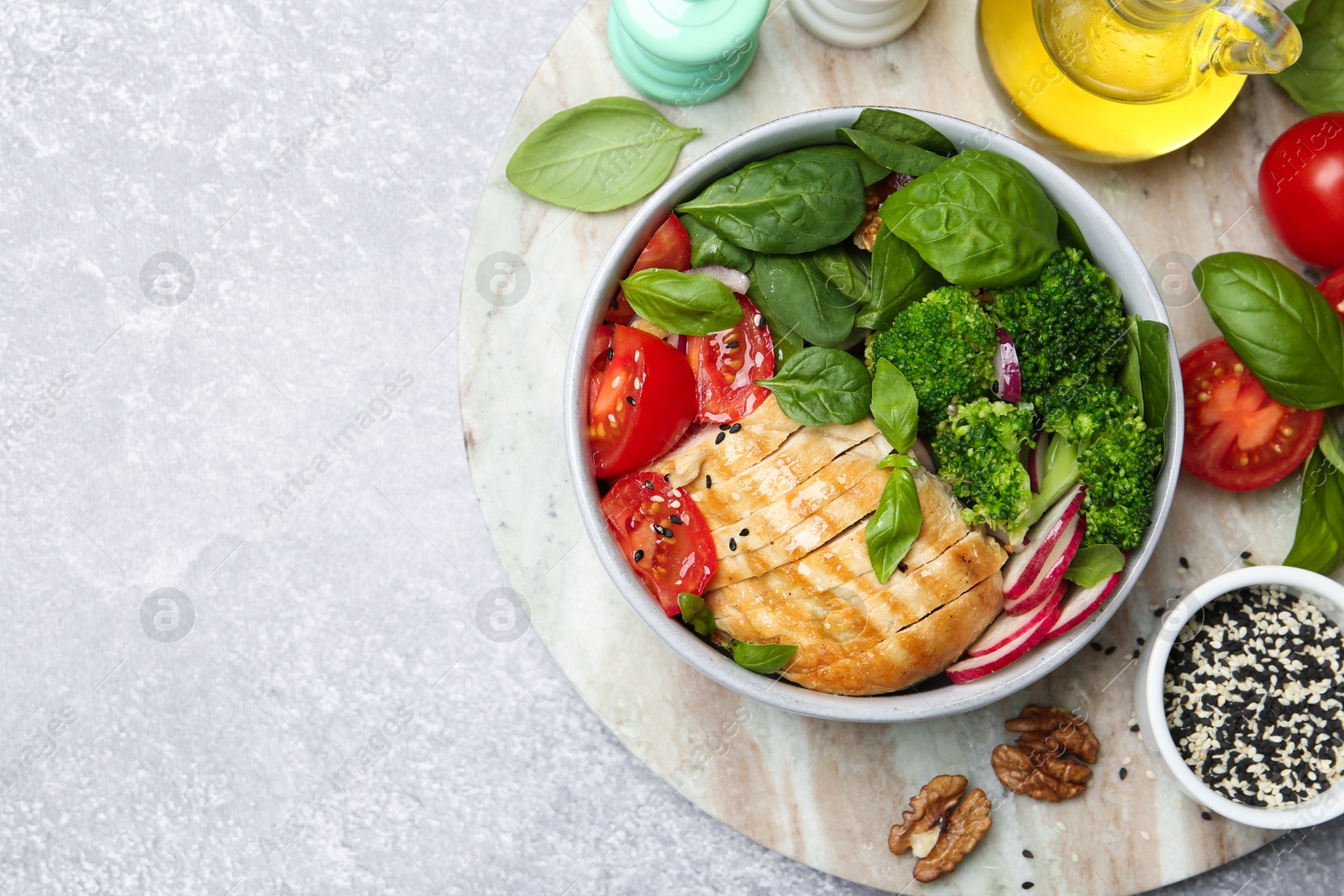 Photo of Healthy meal. Delicious chicken, vegetables and spinach served on table, flat lay. Space for text