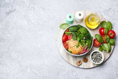 Photo of Healthy meal. Delicious chicken, vegetables and spinach served on table, flat lay. Space for text