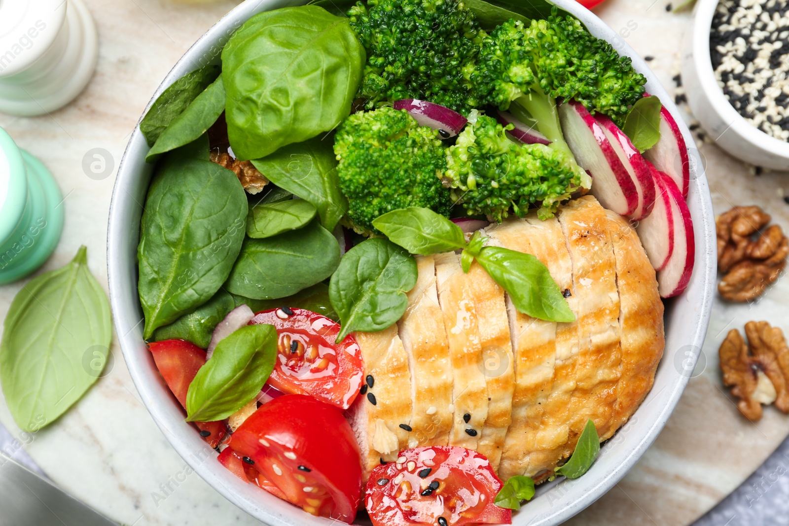 Photo of Healthy meal. Delicious chicken, vegetables and spinach in bowl on table, flat lay