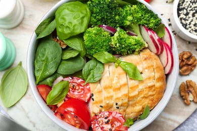 Photo of Healthy meal. Delicious chicken, vegetables and spinach in bowl on table, flat lay