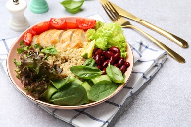 Photo of Healthy meal. Tasty vegetables, quinoa and chicken breast in bowl on white table